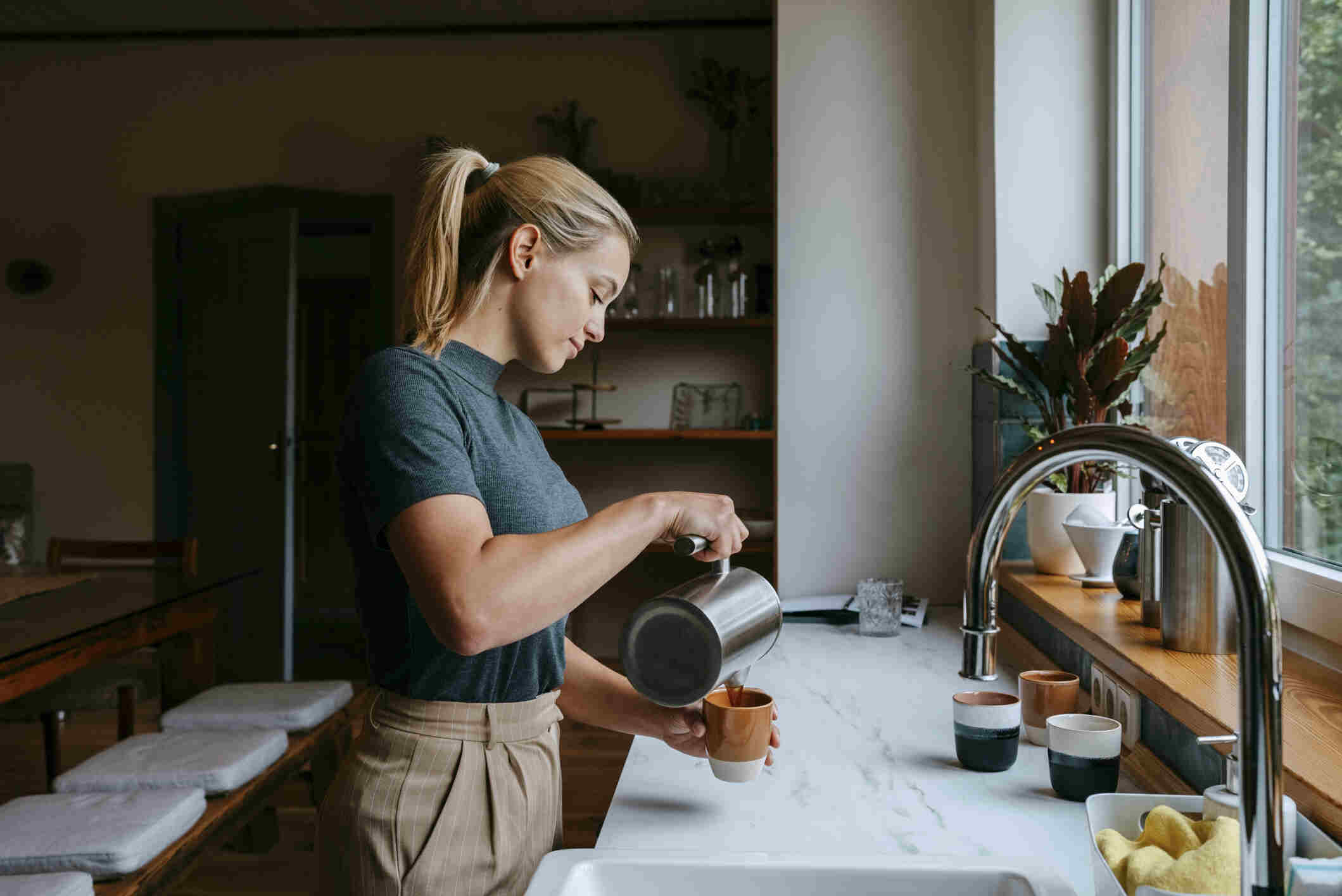 A woman pouring coffee in a rental property in Germany 